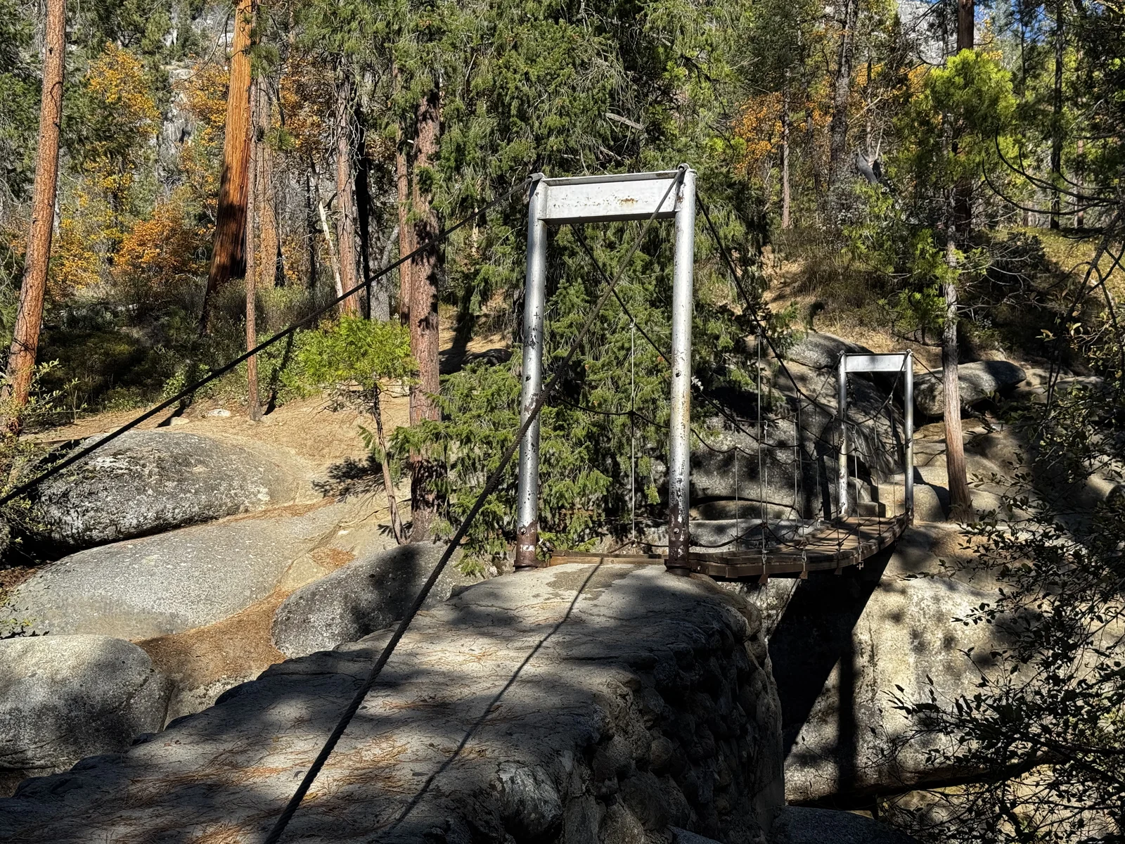 The Wawona Swinging Bridge over the South Fork of the Merced River in autumn